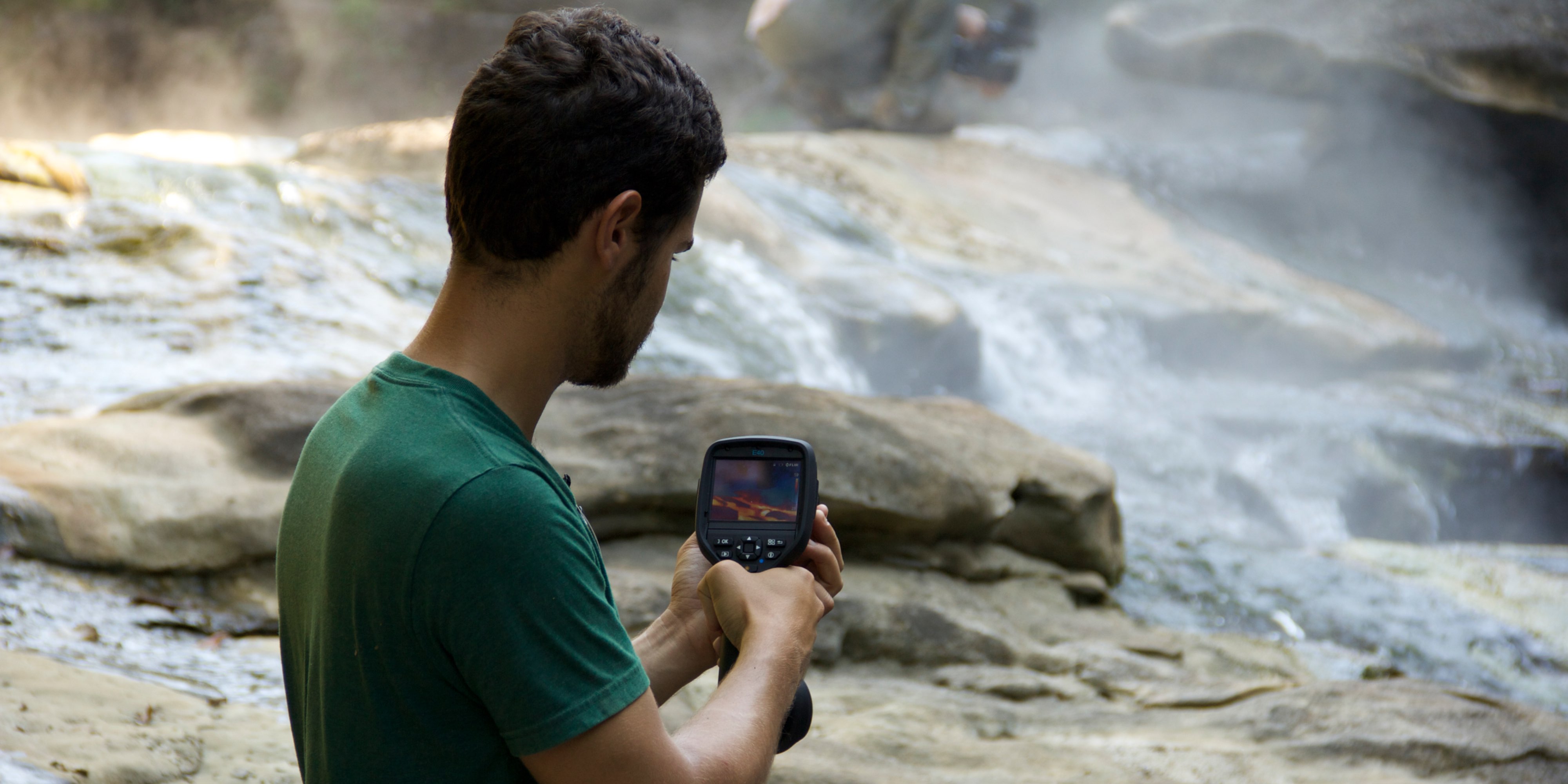 Andr&eacute;s Ruzo using a thermal camera at the boiling river