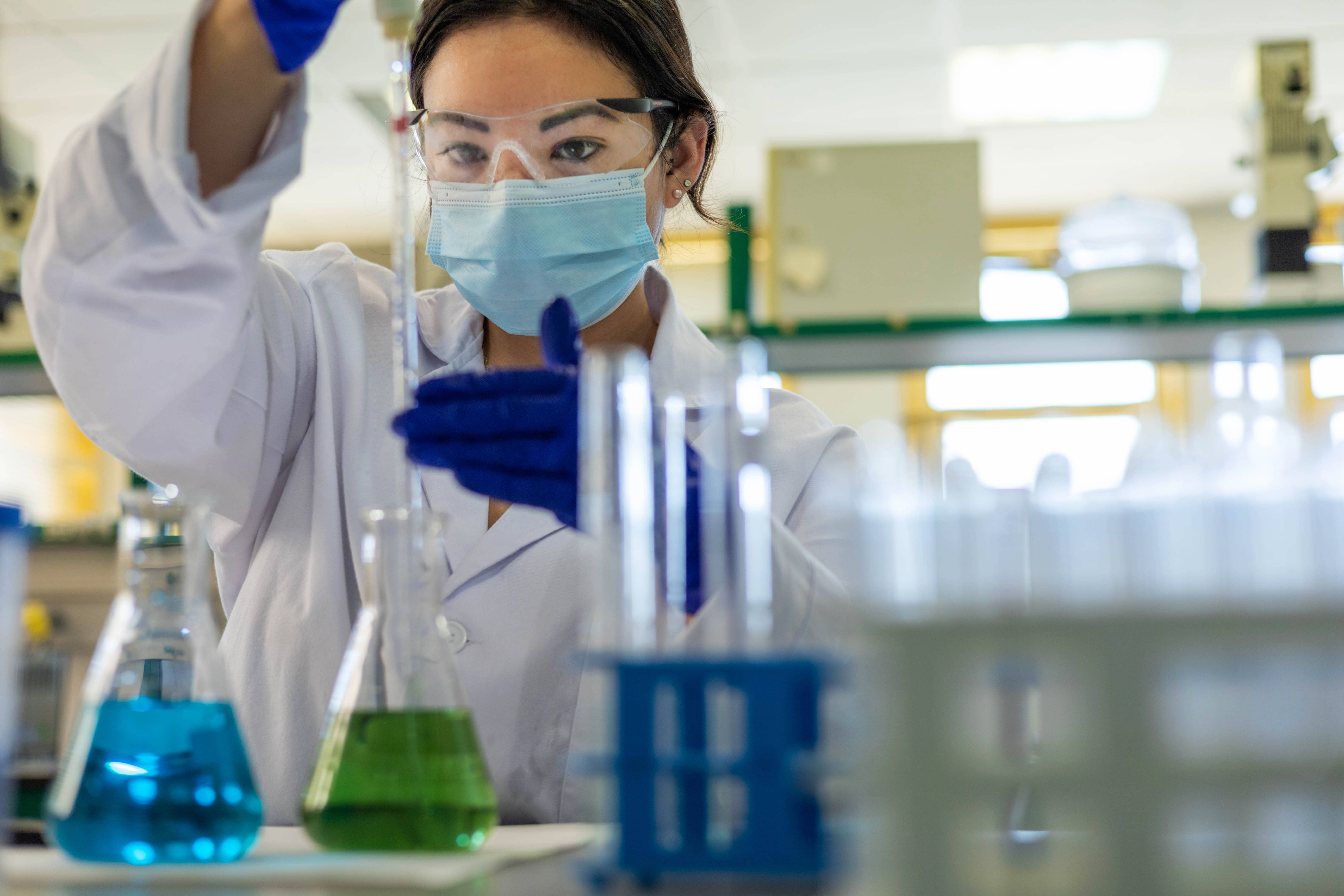Scientist in laboratory testing WFI water system for USP purified water and pharmaceutical compliance