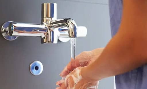 Hands under a faucet