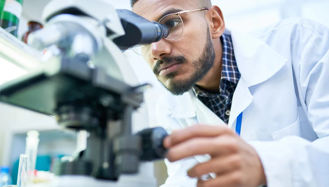 Man looking into microscope