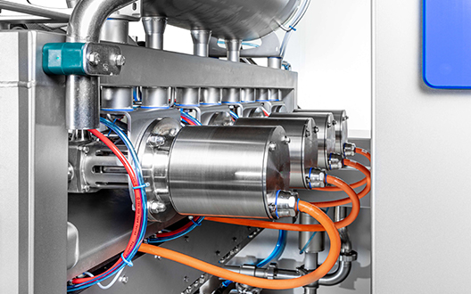 Side view of pumps on FoodJet MDL pizza sauce depositor